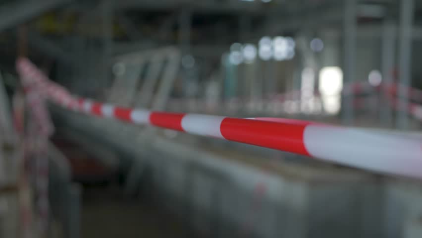 Barricade tape at construction of hangar, warehouse or factory. Production factory line. Red and white attention stop danger tape line. Building industry Royalty-Free Stock Footage #1102546597
