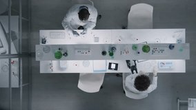 Top view of couple scientists working together at table with microscope and samples in test tubes in laboratory - Powered by Shutterstock - Get 15% off with code: PIKWIZARD15