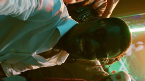 Vertical video: POV of funky people filming video at party, making memories on dance floor with friends at nightclub. Cheerful persons taking pictures and recording vlog at modern celebration - Powered by Shutterstock - Get 15% off with code: PIKWIZARD15