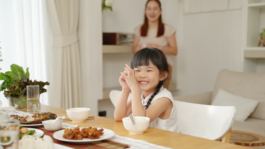 Mother serving milk to her daughter while sitting at table for breakfast, family relations concept, healthy food
 Royalty-Free Stock Footage #1102557359