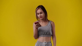 4k video of one girl who emotionally rejoices over yellow background.
