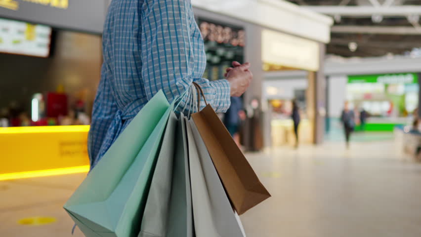 The buyer, The buyer chooses clothes Happily Walks through the mall In the mall, Close-up Pretty woman Chooses clothes for the summer season To become the most beautiful on the holiday, super store
 Royalty-Free Stock Footage #1102559975
