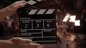Human hands are using a clapperboard on set. Beginning of scene in film or TV television production. Concept of cinematography movie or video crew. Stage and filmmaking equipment background - Powered by Shutterstock - Get 15% off with code: PIKWIZARD15