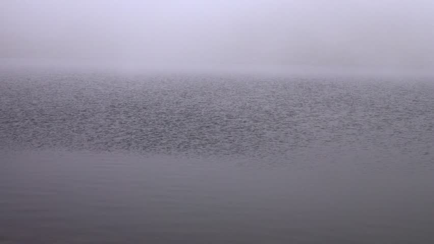 Fog drifted obscuringly into the valley with lake. Thick weather