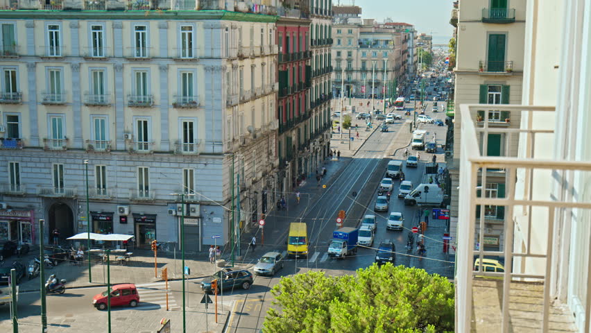 Naples view from the hotel balcony over the busy streets with cars and busses. View over the city of Naples from above in Italy. Royalty-Free Stock Footage #1102576325