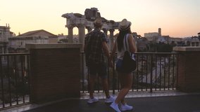 Young couple tourist walking in front of Roman Forum at sunrise. Historical imperial Foro Romano in Rome, Italy from panoramic point of view. - Powered by Shutterstock - Get 15% off with code: PIKWIZARD15