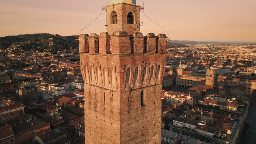 bologna city aerial view drone flying over town center with asinelli tower landmark in the foreground at sunrise dawn Royalty-Free Stock Footage #1102576837
