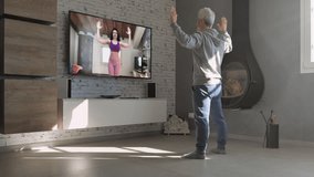 mature person exercise at home watching online workout on television,middle age male training remote with personal trainer livestreaming on tv