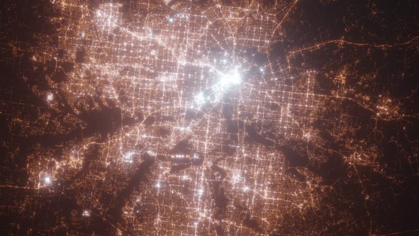 Dallas and Fort Worth (Texas, USA) aerial view at night. Top view on modern city with street lights. Camera is zooming out, rotating clockwise. Vertical video. The north is on the left side