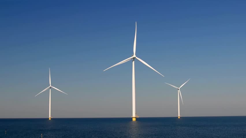 Windmill park in the ocean aerial view with wind turbine Flevoland Netherlands Ijsselmeer. Green energy. 