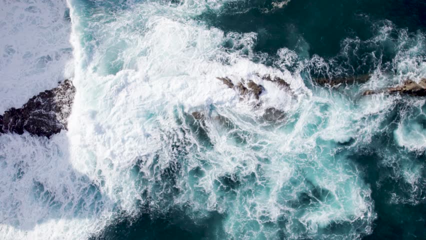 Aerial top down of turbulent waters on rocks, Madiera, Portugal