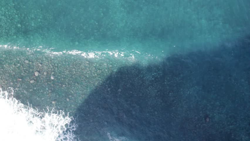 Aerial topdown of large turquoise waves, Madiera, Portugal