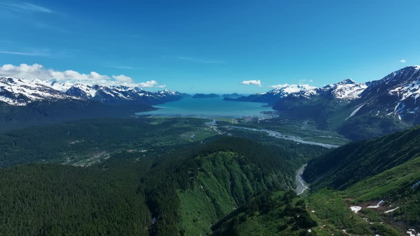 Natural Scenery Of Stunning Glacier, Towering Mountains, And Pristine Wilderness In Alaska. wide aerial