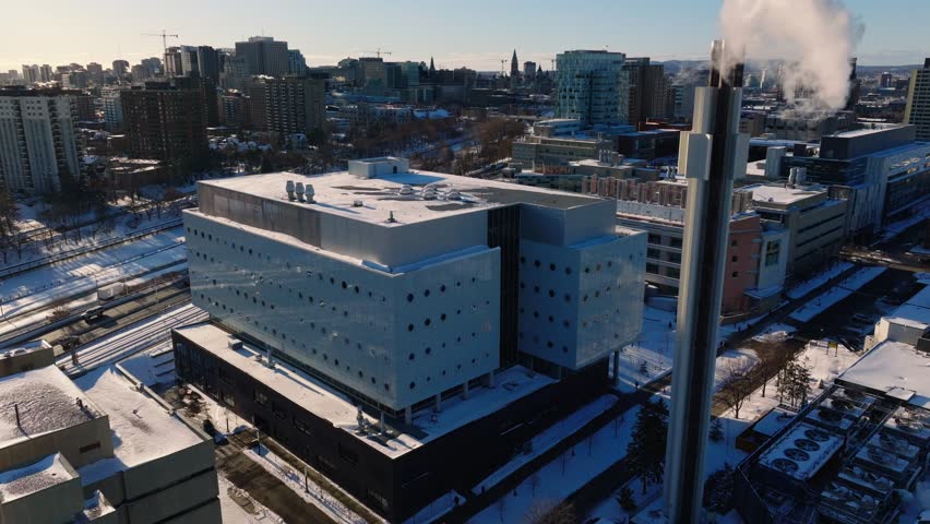 Downtown Ottawa in winter with parliament building in background and University of Ottawa in foreground