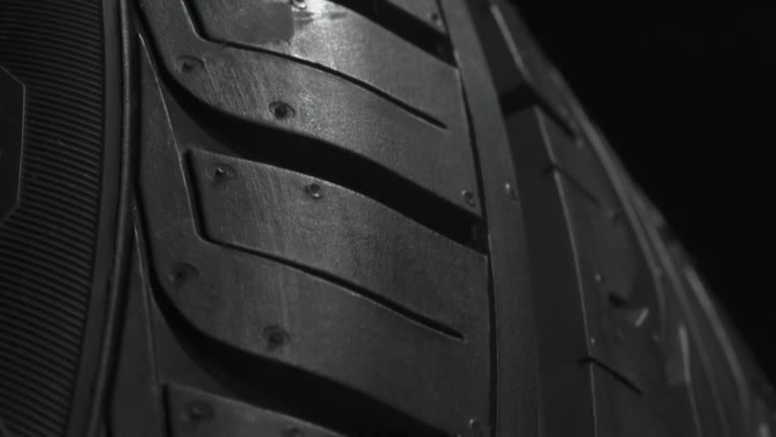 Tire Smokes While Drifting. The spinning wheel rubs against the asphalt and creates a cloud of white smoke on a black background Royalty-Free Stock Footage #1102595523