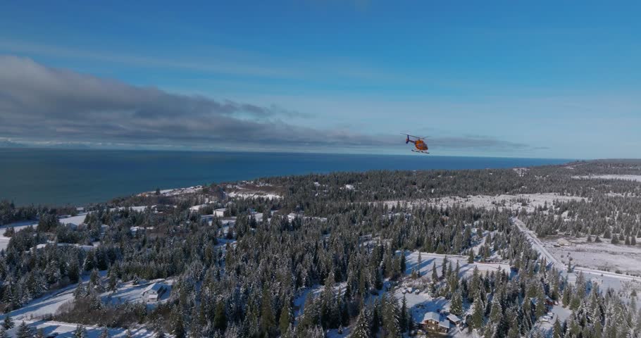 Drone footage of a helicopter taking off from an emergency response center on the Kenai Peninsula of Alaska.