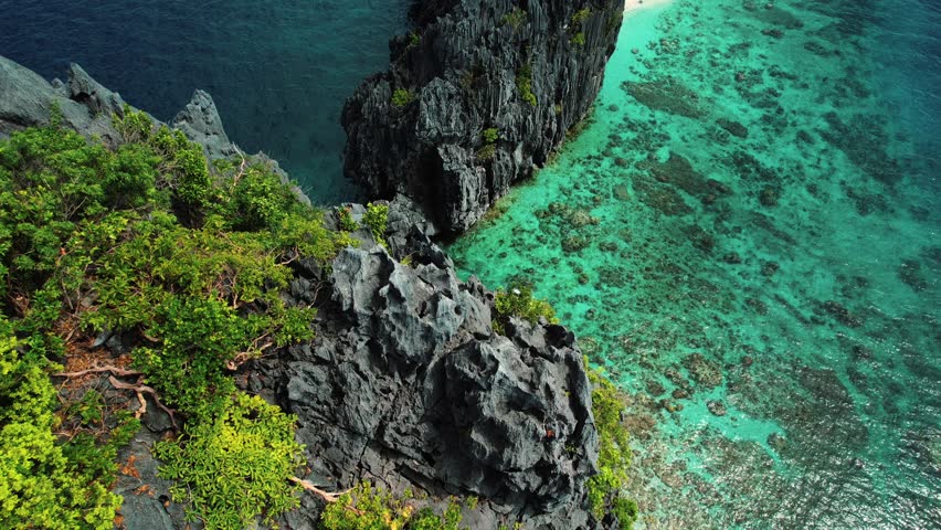 The Big Lagoon 4k Drone Flys Down Cliff in Palawan Philippines Royalty-Free Stock Footage #1102598947