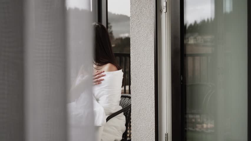 Mountain Balcony Retreat: Woman Savoring Coffee and Croissant