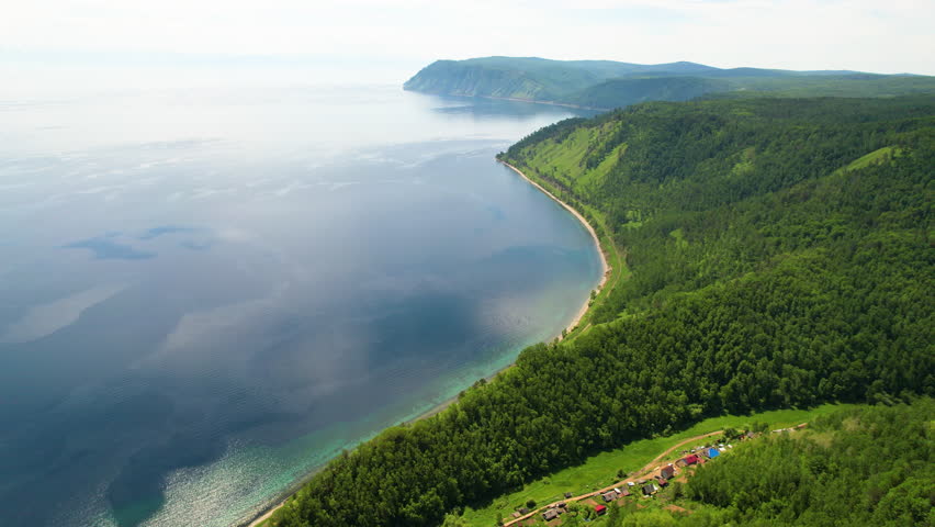 Beautiful summer landscape. The shore of Lake Baikal on a sunny day, mountains covered with forest. 4k footage Royalty-Free Stock Footage #1102600925