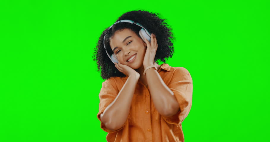 Green screen, woman and dance to happy music in studio, freedom or celebration in good mood. Headphones, female model and dancing to audio, sound and relax while listening to radio, streaming and joy Royalty-Free Stock Footage #1102601999