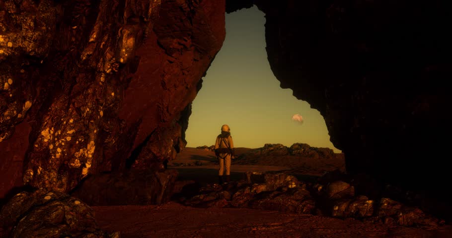 Astronaut on an unknown planet looking up. Red planet.