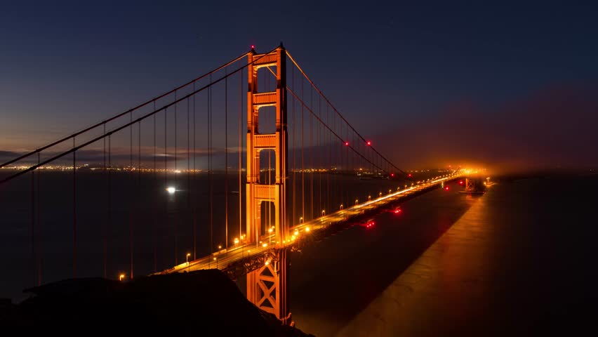 Golden Gate Bridge timelapsing view from dark to sunrise as the famous landmark in San Francisco USA Royalty-Free Stock Footage #1102604115