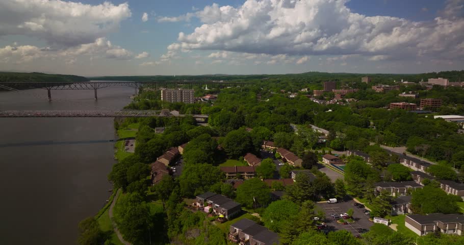 Aerial of Poughkeepsie Hudson River waterfront Bridge on beautiful sunny day Royalty-Free Stock Footage #1102605371