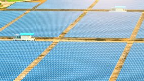 The solar panels of the power plant create a striking pattern of shining rectangles. They stretch out as far as the eye can see, Produce clean energy for a sustainable future. Industrial concept. 4K
