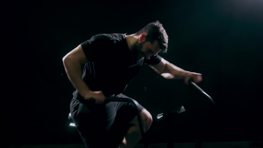 Man doing fitness training on bike at gym, workout for sports motivation and cardio exercise for strong body. Face of person with testosterone getting healthy and moving for wellness and health