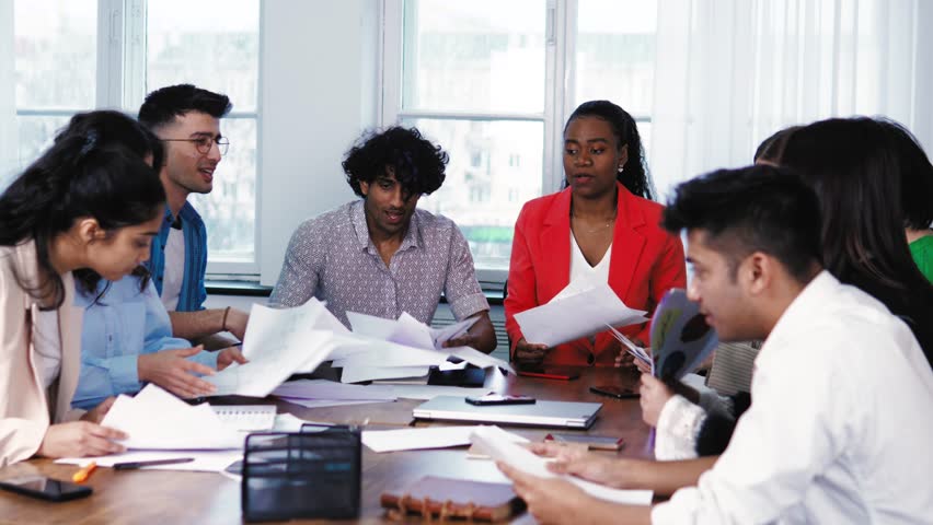 Happy overjoyed students are excited about holidays or vacation, throwing papers away, celebrating the end of semester, success, friendship. Colleagues dancing feeling joy of succeded work at office