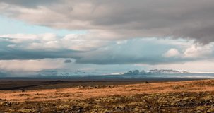 Timelapse video of the Iceland countryside during fall season. A galcier and mountains can be seen in the background, clouds in the sky