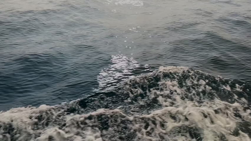 Slow Motion Waves and Wake on a Rocky Sea