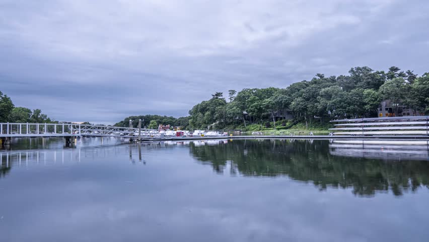 Timelapse of Saugatuck River in Westport Connecticut with still water and moving clouds during blue hour