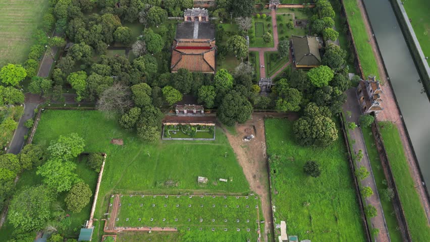 Aerial footage above the Imperial city of Hué in central Vietnam. Heart of the Nguyen dynasty this huge complex attracts lot of tourist. Camera is moving backward on the west area 2-3