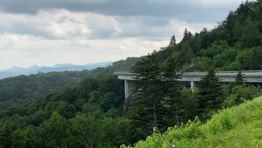 Blue Ridge Parkway and the Linn Cove Viaduct hugging the face of Grandfather Mountain, recognized internationally as an engineering marvel protecting the fragile habitat of area. 