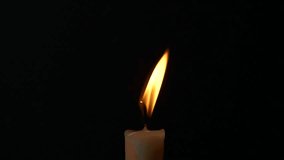 Close-up single candle burning on dark black background, candle fire flame light - Powered by Shutterstock - Get 15% off with code: PIKWIZARD15