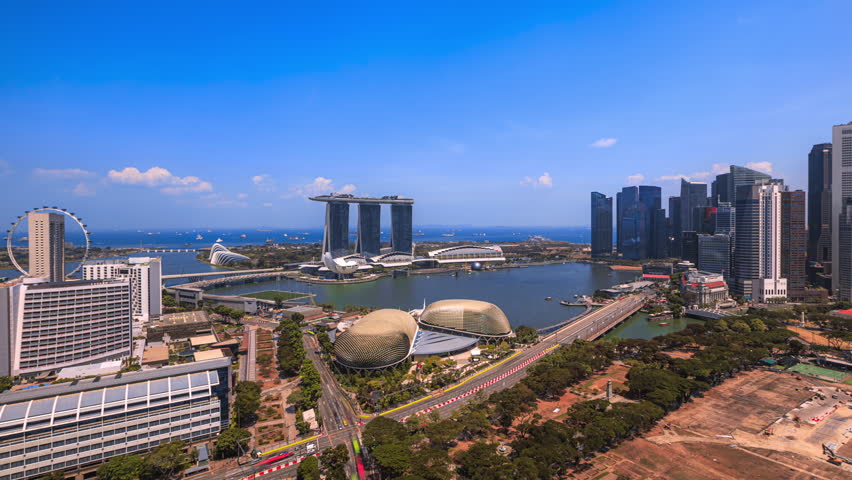 Singapore Daytime Beautiful Time lapse of Singapore city skyline from aerial and high angle overlooking Marina bay and CBD area. Tilt up motion timelapse. Prores Full HD Royalty-Free Stock Footage #1102625117