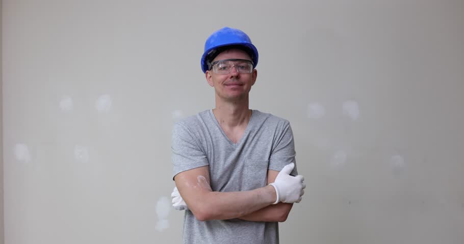 Foreman in protective helmet and gloves shows thumb up