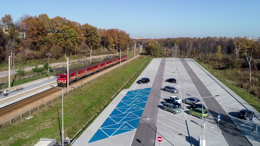 Park and Ride. P+R big parking lot and fast city train to Krakow city center leaving a small railway station in peripheral Swoszowice district. Modern ecological way of transportation to town center