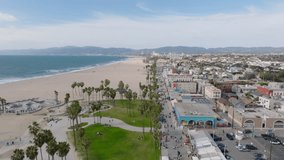 Amazing aerial footage of Venice beach. Sandy beach with relaxing zone, palm trees and skatepark. Los Angeles, California, USA