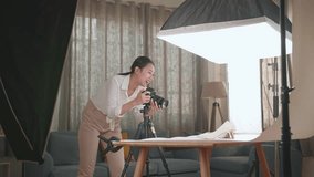 Asian Female Photographer Taking Photos Of Women's Shoes In Home Studio 
 - Powered by Shutterstock - Get 15% off with code: PIKWIZARD15