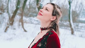 Fantasy happy woman stands in winter forest under snowfall cold nature white snow dark trees. Girl princess beauty smiling face perfect pale skin enjoy snow fresh air. Vintage style lady red dress 4k - Powered by Shutterstock - Get 15% off with code: PIKWIZARD15