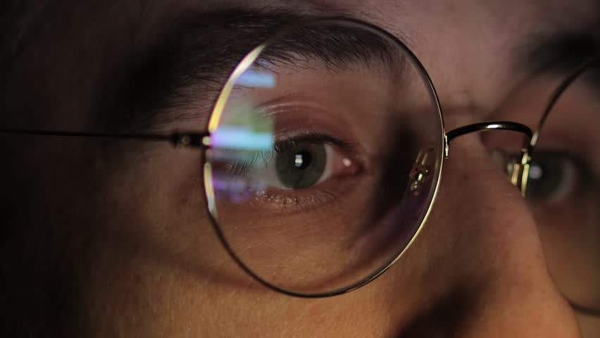 Internet Addiction, Phone Screen, Brainwashing, Web Surfing, Fake News. Media deception. smartphone screen is reflected in glasses. men's eyes in glasses close-up, watch the news on the smartphone