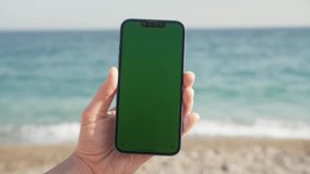 Green Screen chroma key Handheld Smartphone. Travel with phone concept, application mock up. Sunset on a tropical beach. - Powered by Shutterstock - Get 15% off with code: PIKWIZARD15