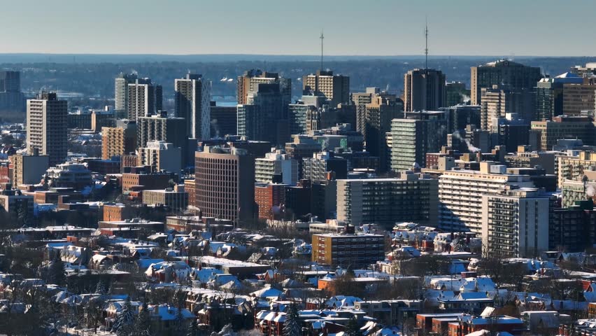 Slow and long panning shot of the downtown Ottawa city skyline shot from a telephoto perspective during winter