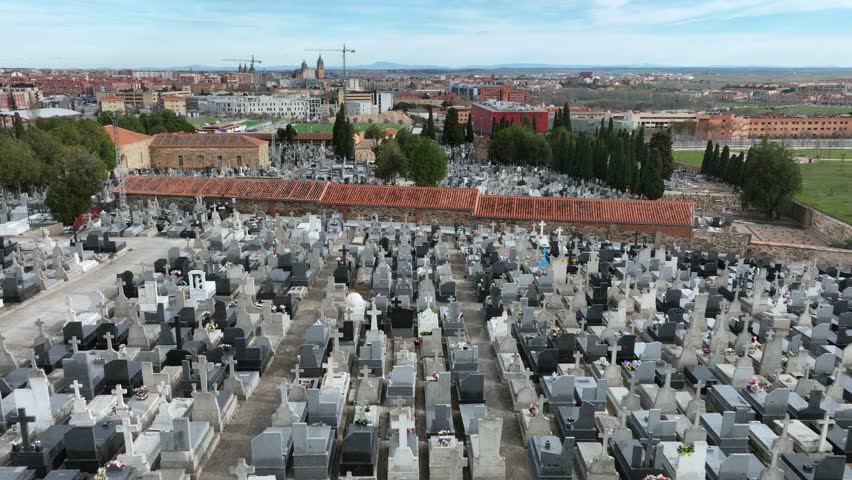 Establishing shot of a big cemetery next to a city, aerial view