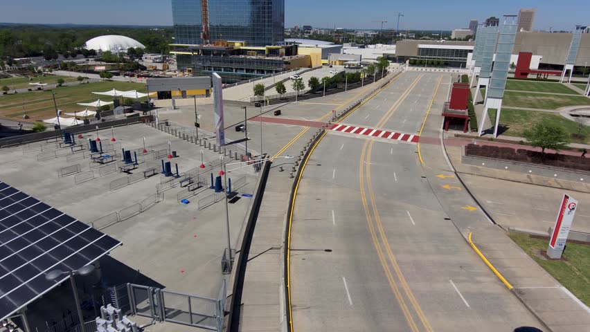 Atlanta, Georgia USA - 4 6 2023: ascending aerial footage of a gorgeous spring landscape with skyscrapers, office buildings, lush green trees and tower cranes in the city skyline