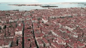 Aerial view of the Venice city on the water and rooftops. Basilica and canals. Aerial flight down Venice canal. Aerial drone panoramic video of Venice, Italy.