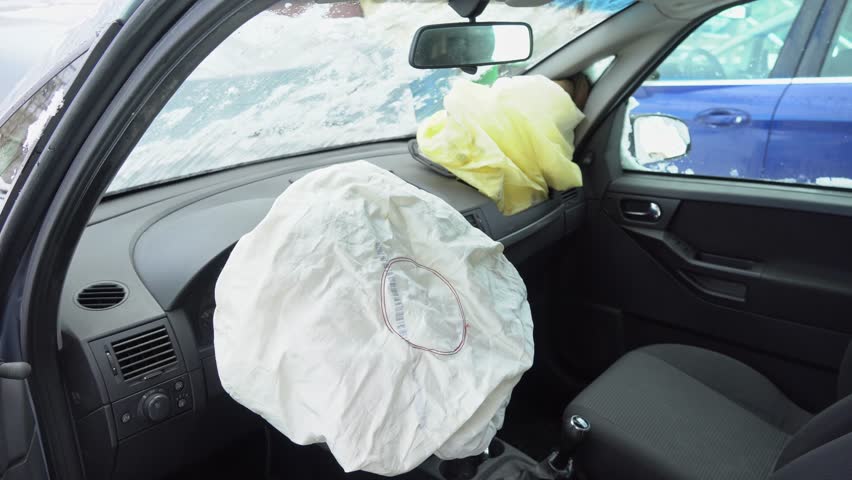 Deployed car airbags after a collision, car accident, vehicle security system after car crash. Deflated air bag Royalty-Free Stock Footage #1102649405