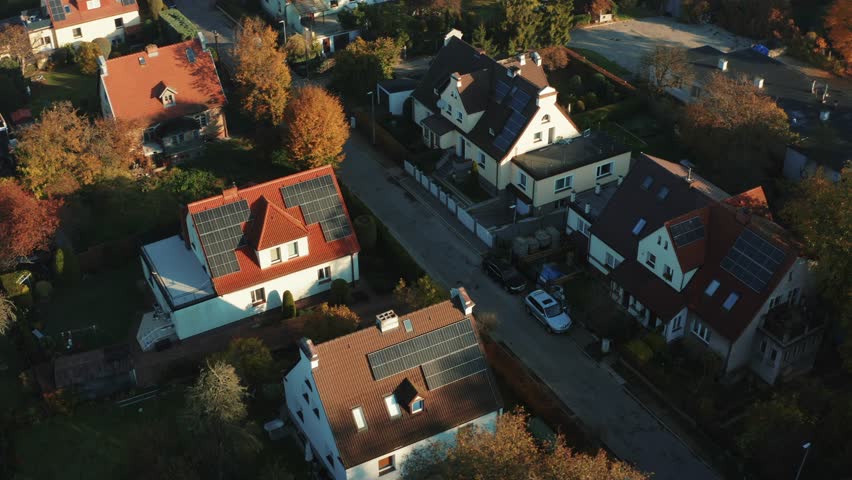 Modern countryside houses with solar panels on rooftops aerial view. Top down shot of a flight over solar panels on the roof of a suburban house building. Production of renewable energy concept. Royalty-Free Stock Footage #1102649449